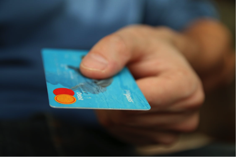 A man paying with a debit card
